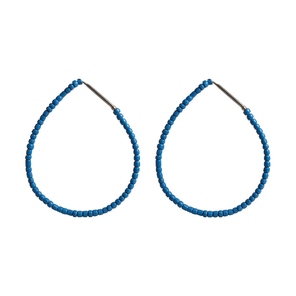 Pair of blue beaded hoop earrings on a white background
