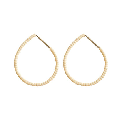 Butter Emmanuelle Hoops featuring cream white colour beads on silver hoops