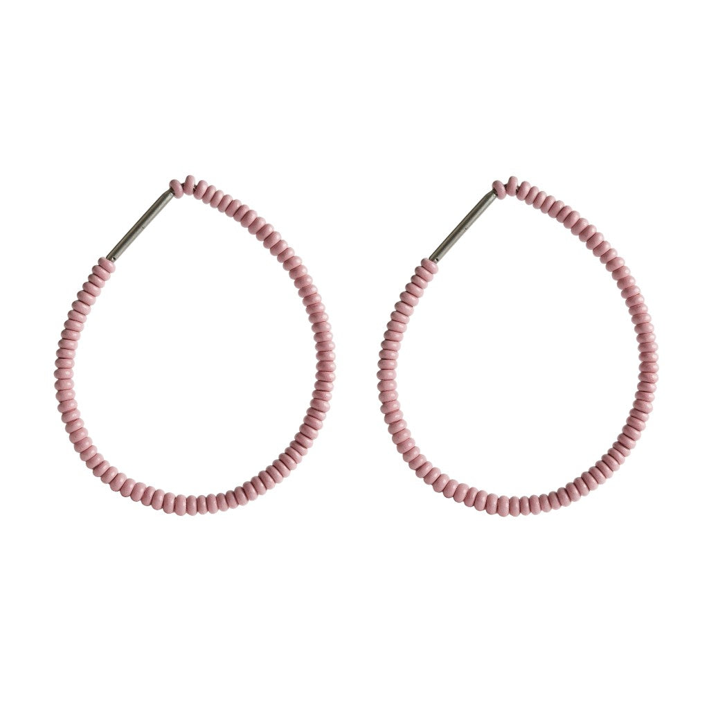 Pair of pink beaded hoop earrings on a white background