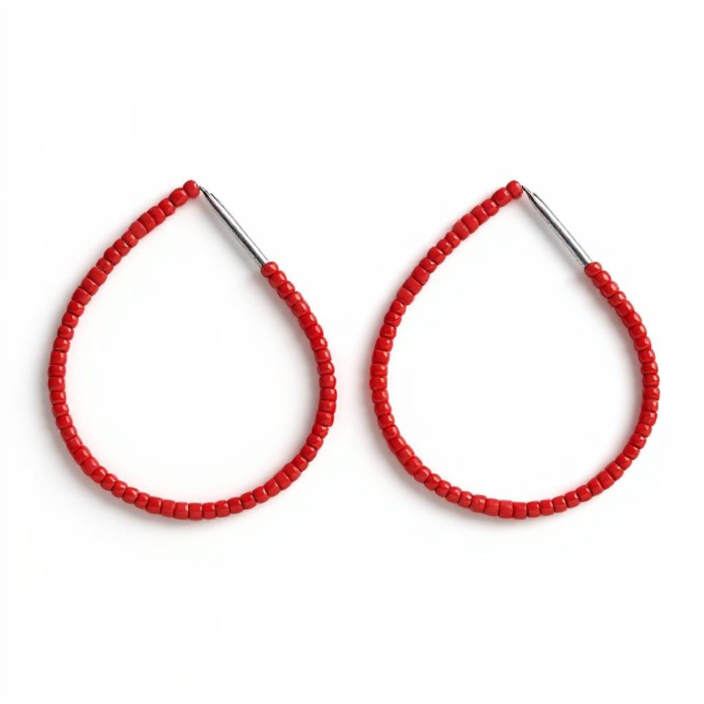 Red beaded sterling silver hoop earrings on a white background